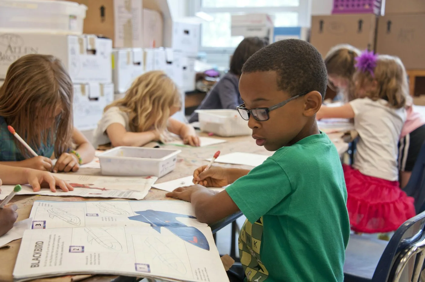 Students using classroom learning technology with teacher support