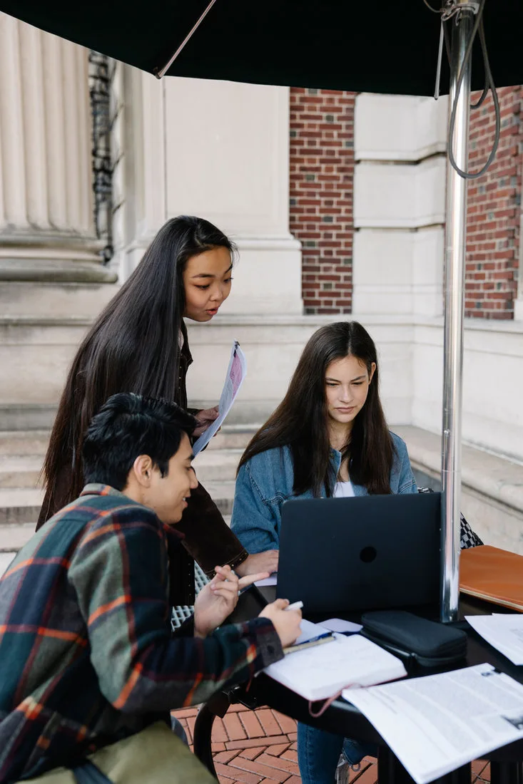 Teacher helping students solve a computer-based learning task