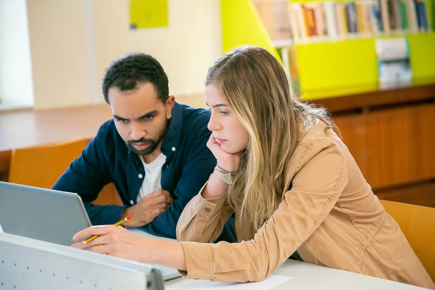 Students researching together with digital education tools in a library