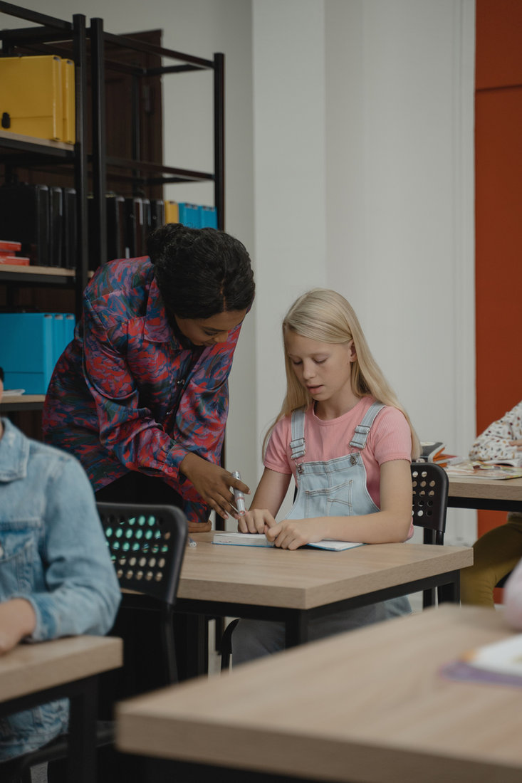 Teacher guiding a student during a personalized digital learning session