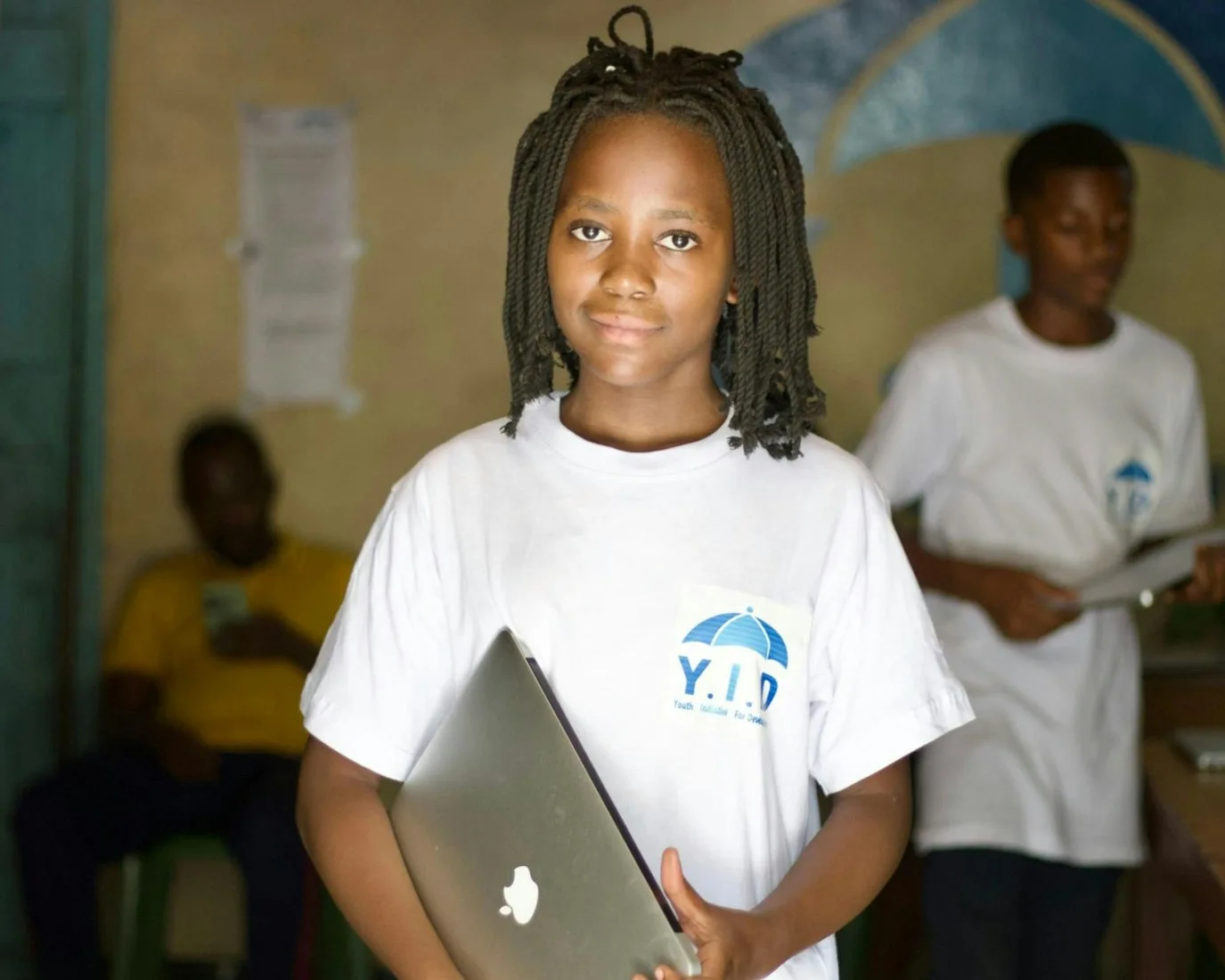 Student holding a laptop for a supervised AI tutoring activity